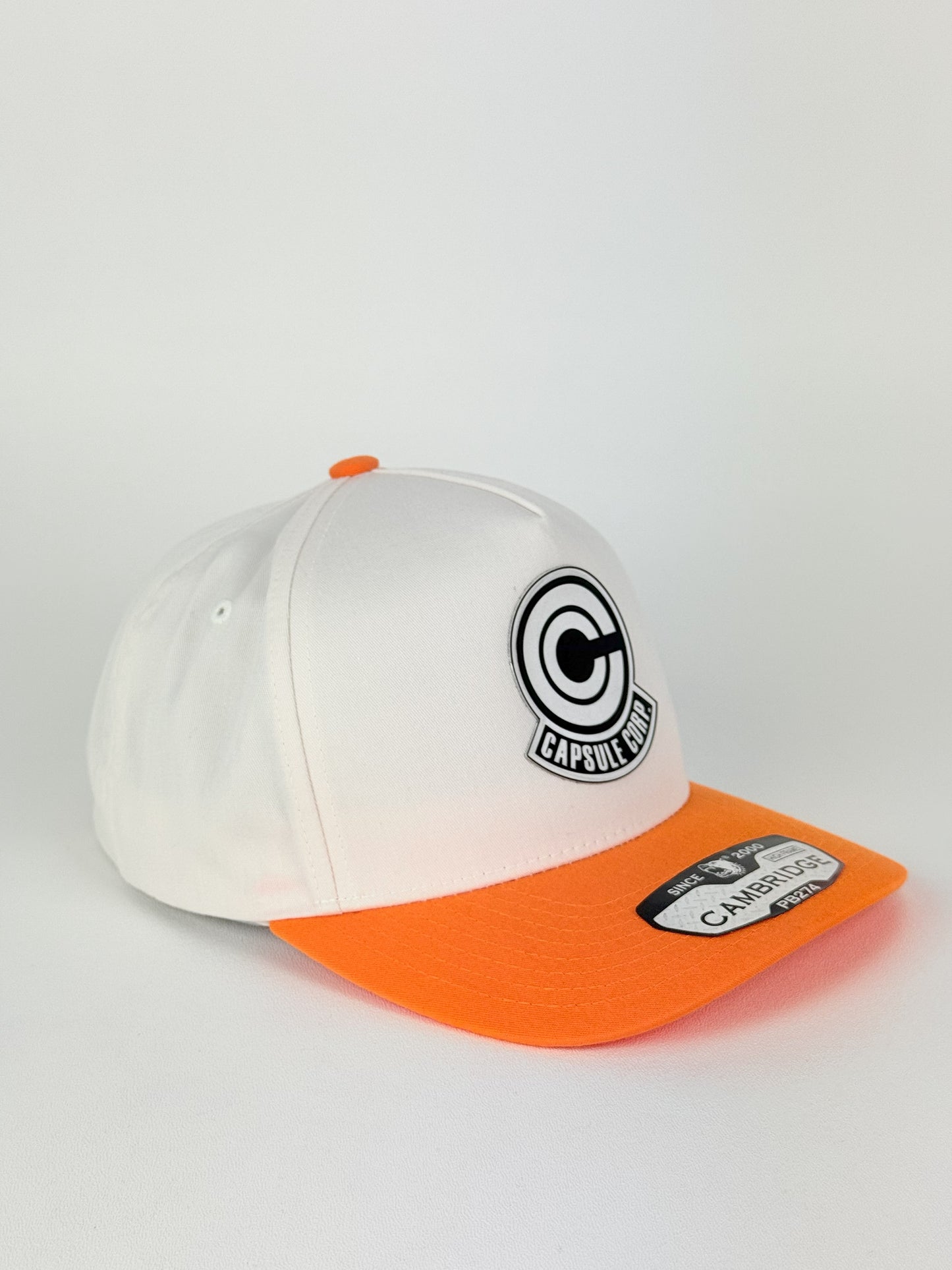 Capsule Corp Trucker Hat – PB274 High Frame (Cream/Orange)